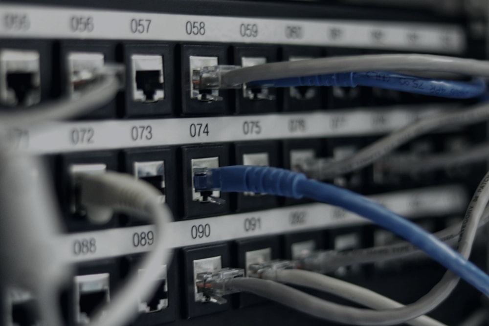 Network patch panel being worked on by hand